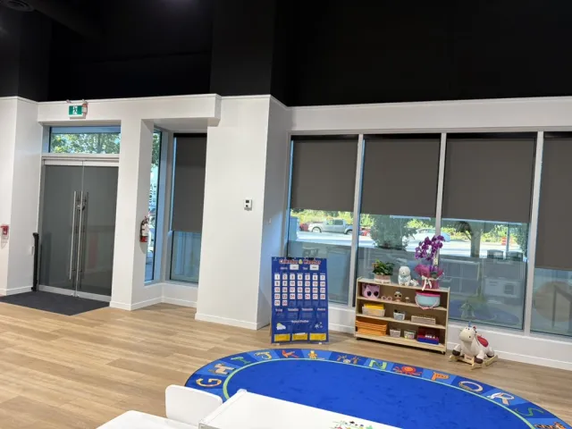 GrowVille's bright classroom with an alphabet rug and big windows