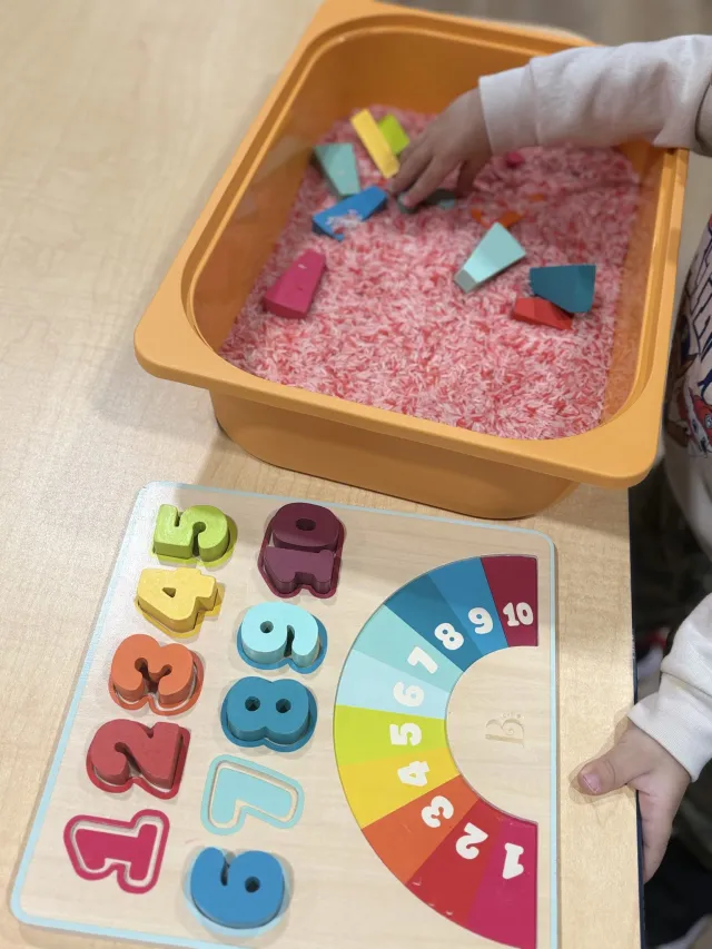 Hands-on learning: a sensory rice bin and a wooden number puzzle